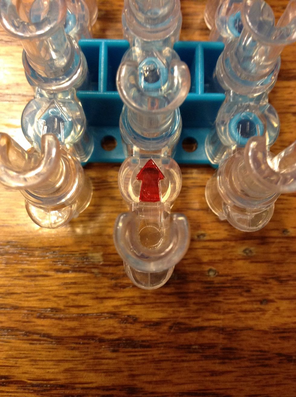 Start with your loom facing upwards with the arrow pointing away from you.