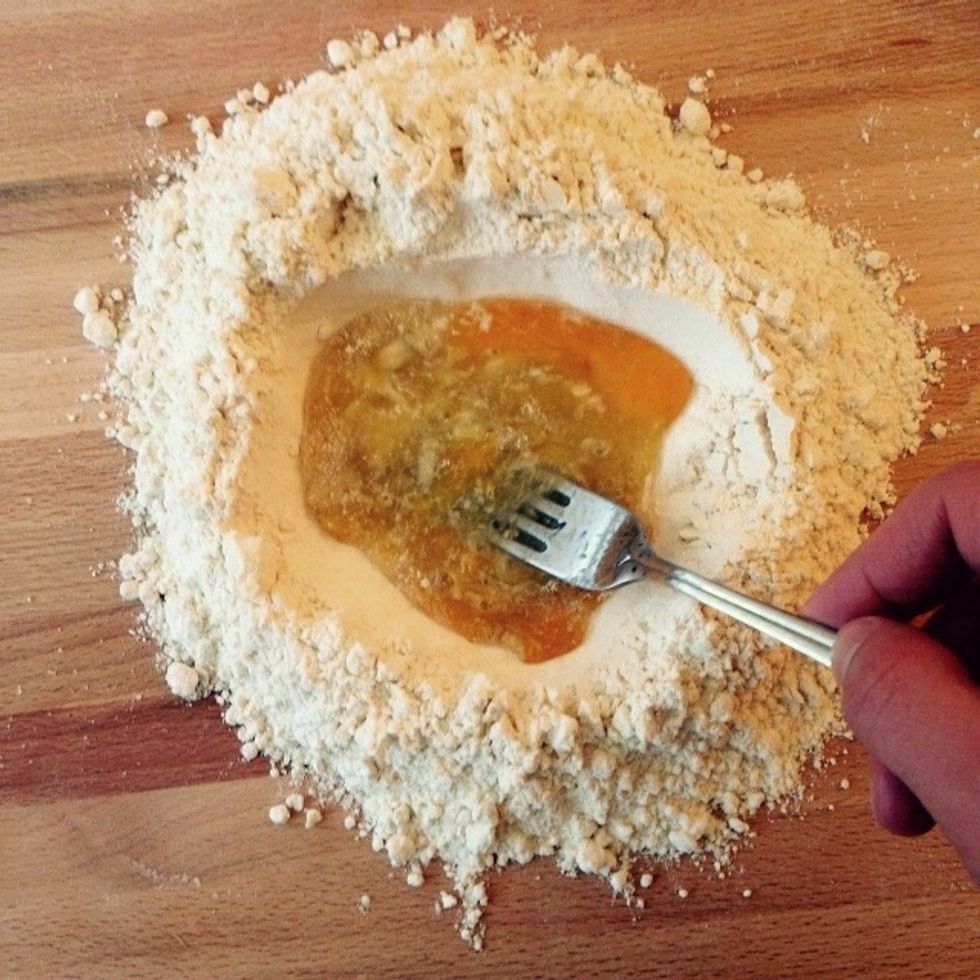 Start working it with a fork, scooping in some flour gradually working your way from inside out