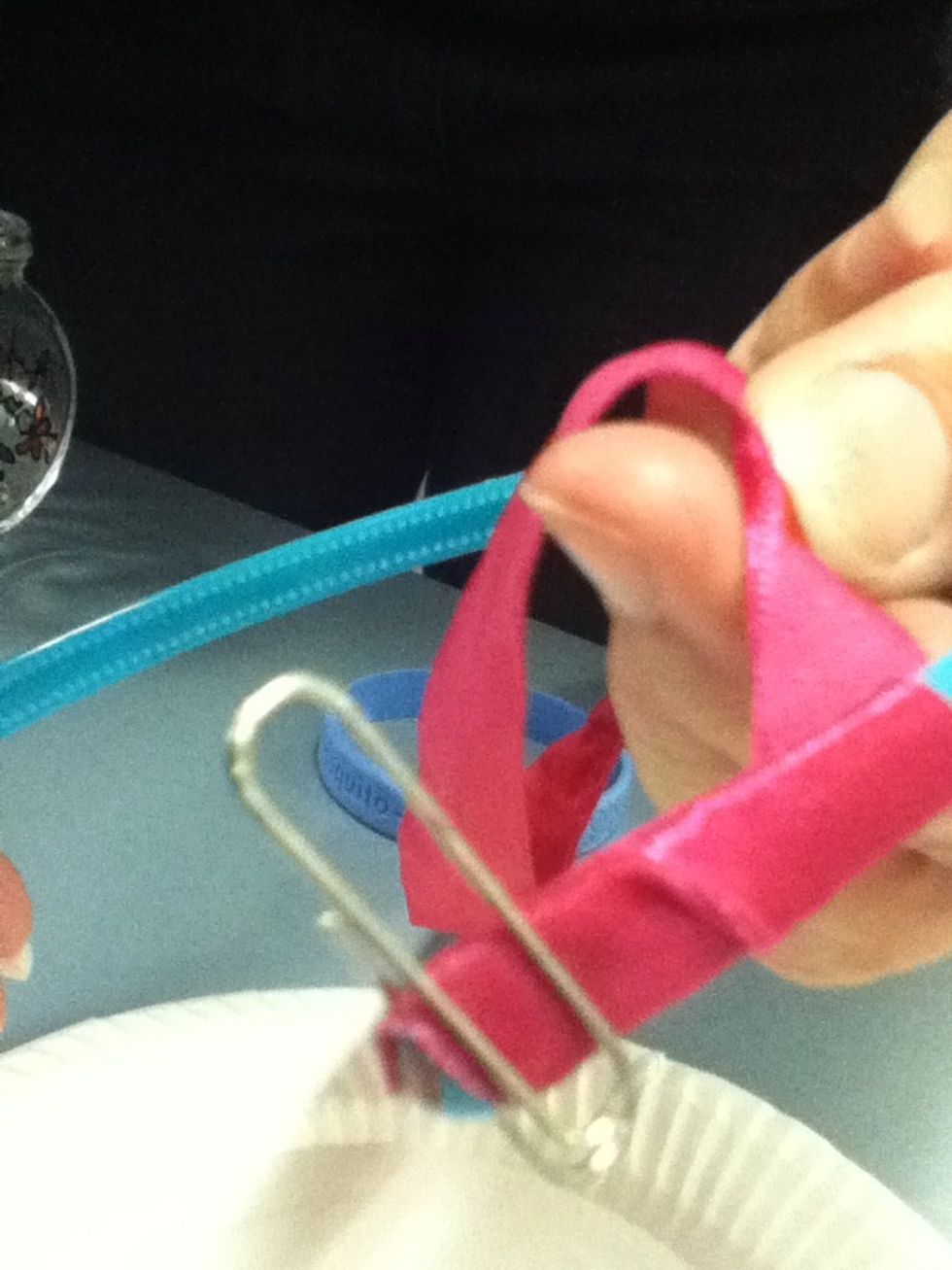Start wrapping ribbon carefully. Use a paper clip to hold ribbon in place.