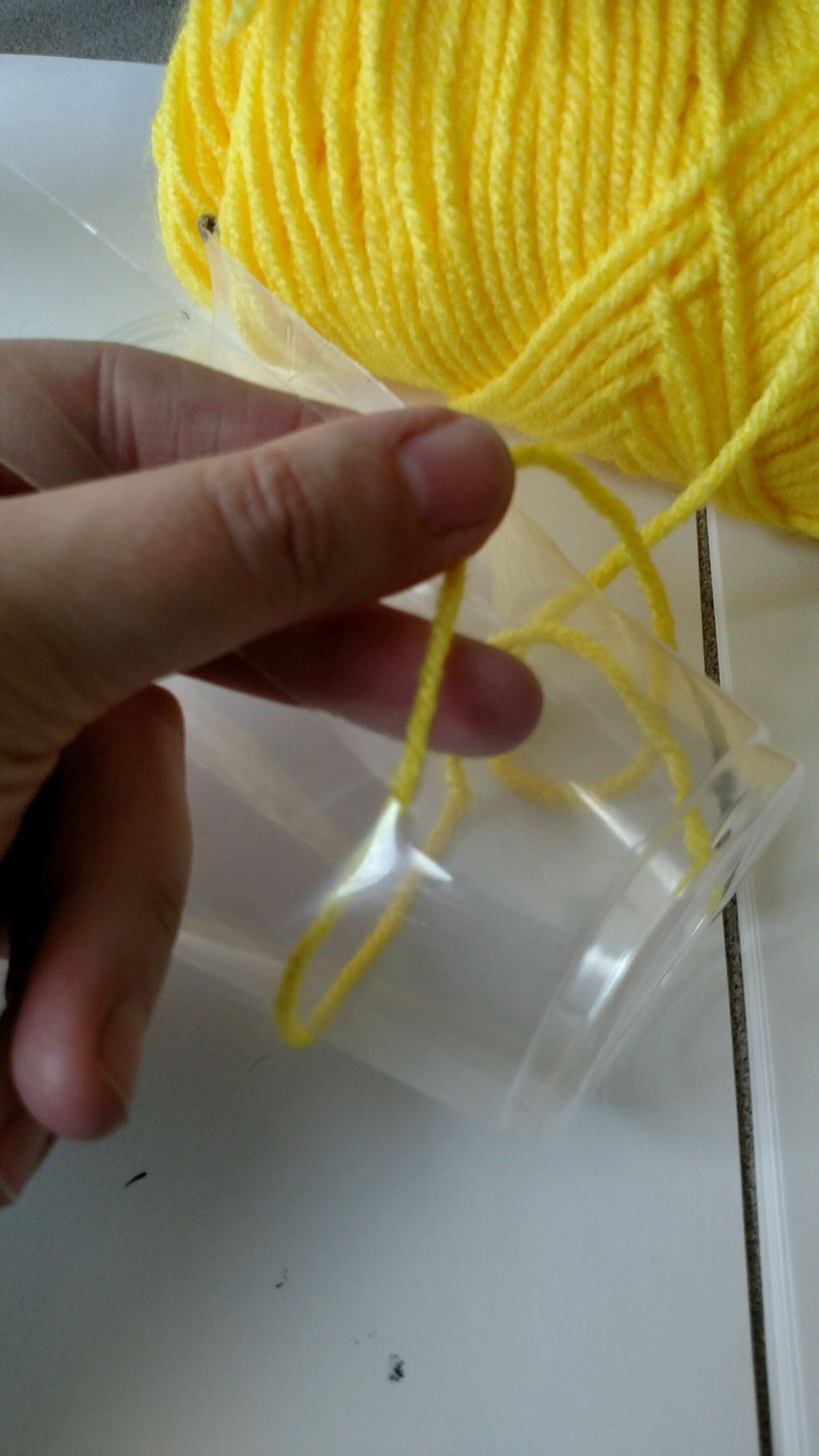 Start your over, under, over, under weave. This time it's kind of more like in, out, in, out because of the cup's cylindrical shape. Keep traveling around the cup.