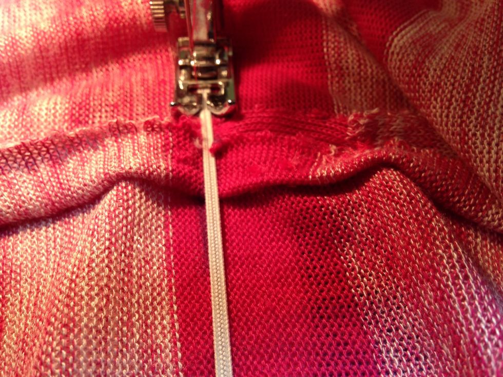 Starting at one of the side seams, pull elastic tightly while stitching all the way around.