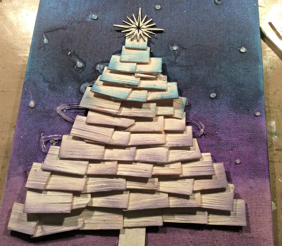 Starting at the bottom of your canvas, start gluing your wood chips on to create your tree. I then swiped over the wood with DI in Concord Grape and Faded Jeans