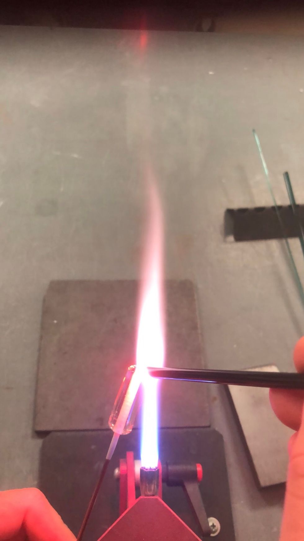 Starting at the end, apply an even stripe of the Oracle-Black down the length of the bead.