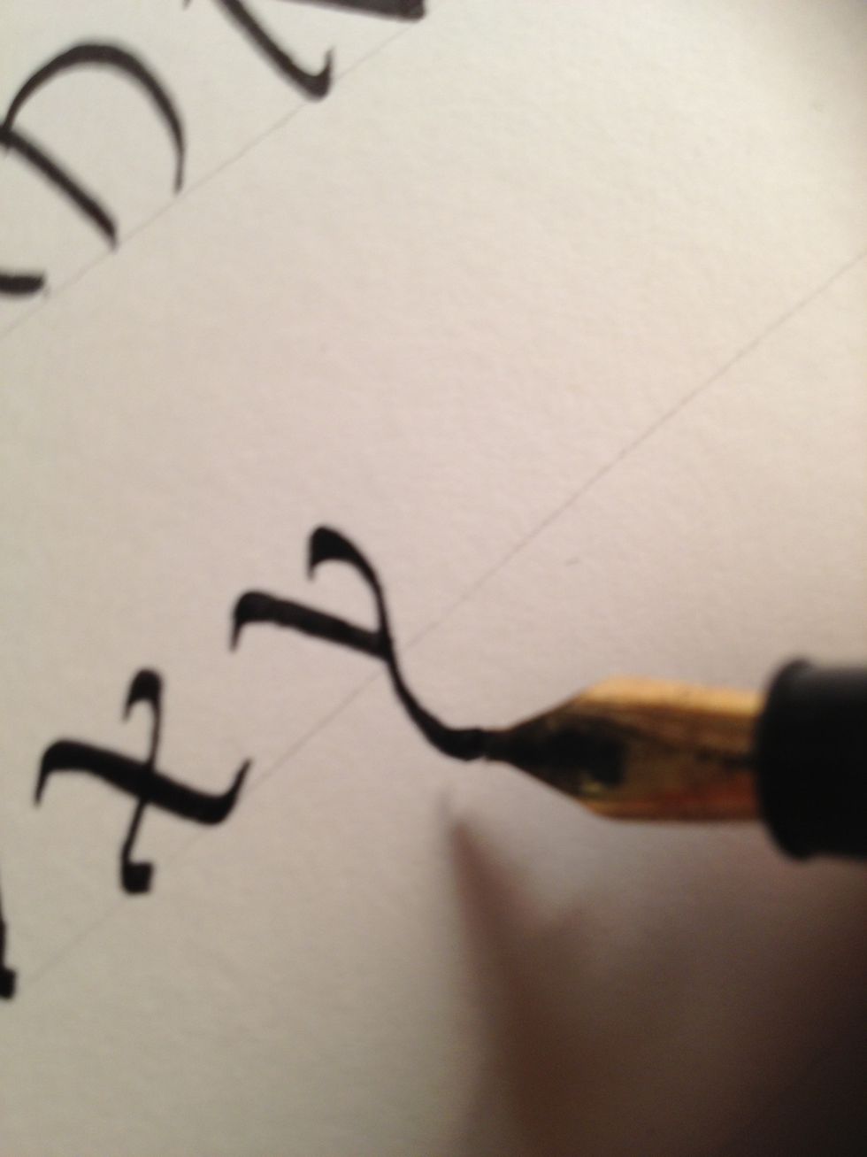 Starting at the top, make the second stroke. Note how it is "wavy"; rather than continuing in a straight line, it curves one way then the other. Add an exaggerated flourish at the top.