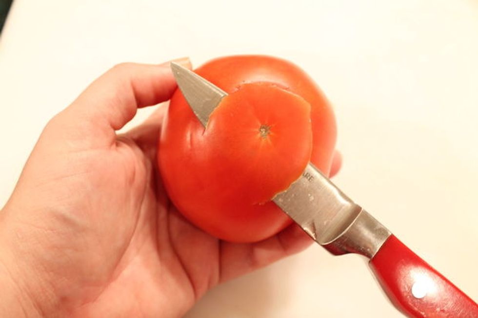 Starting from about 3/4\u201d from the center, cut a strip of the skin across the bottom that is about 1\u201d wide and about 1 \u00bd\u201d long.