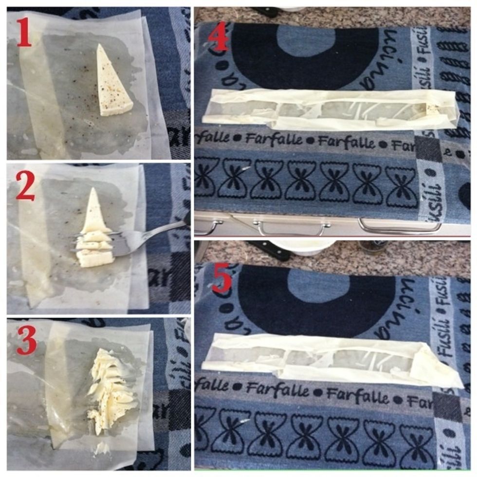 Starting from one outer side: 1. Put a piece of cheese on phyllo and add pepper; 2. Use fork to 'smash' the cheese; 3. Like this; 4. Fold both outersides to the inside; 5. Start folding a triangle...\ue234