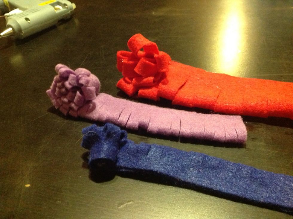 Starting from one side, roll the felt snugly until you get to the end, glueing as you go.