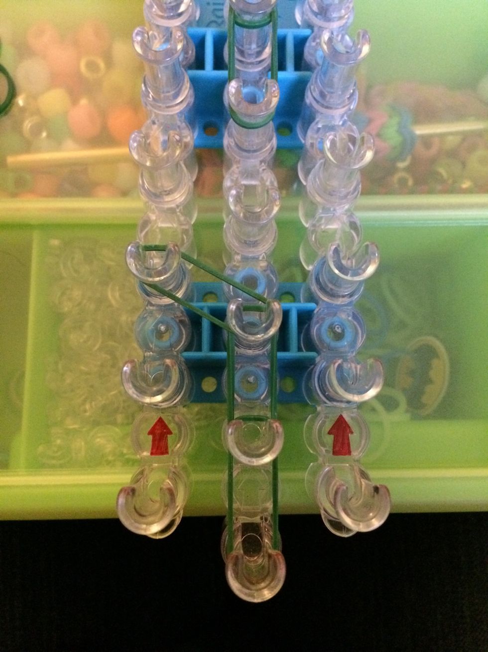 Starting from the center peg, place one band to the left.