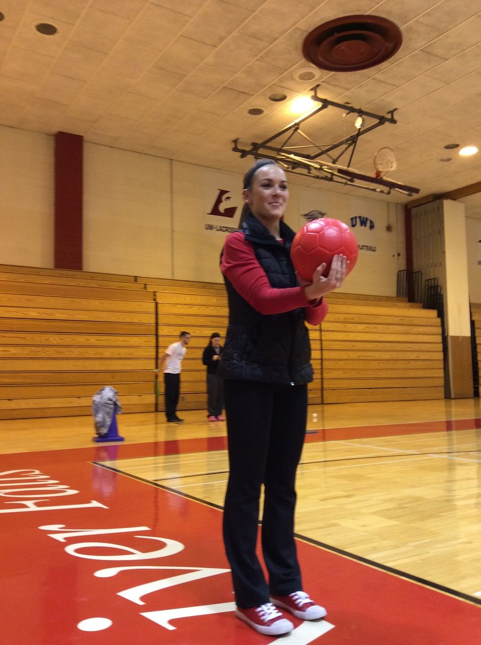 Starting stance with ball in dominant hand. No dominant hand supports back of ball.