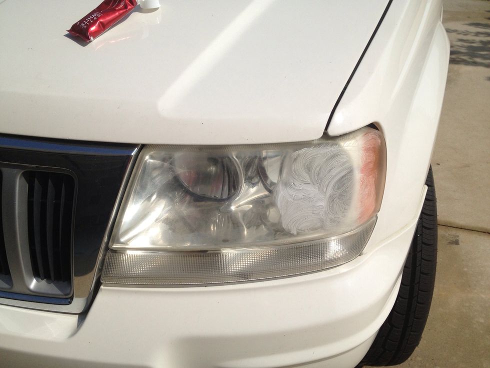 Starting to apply the toothpaste to the top corner.