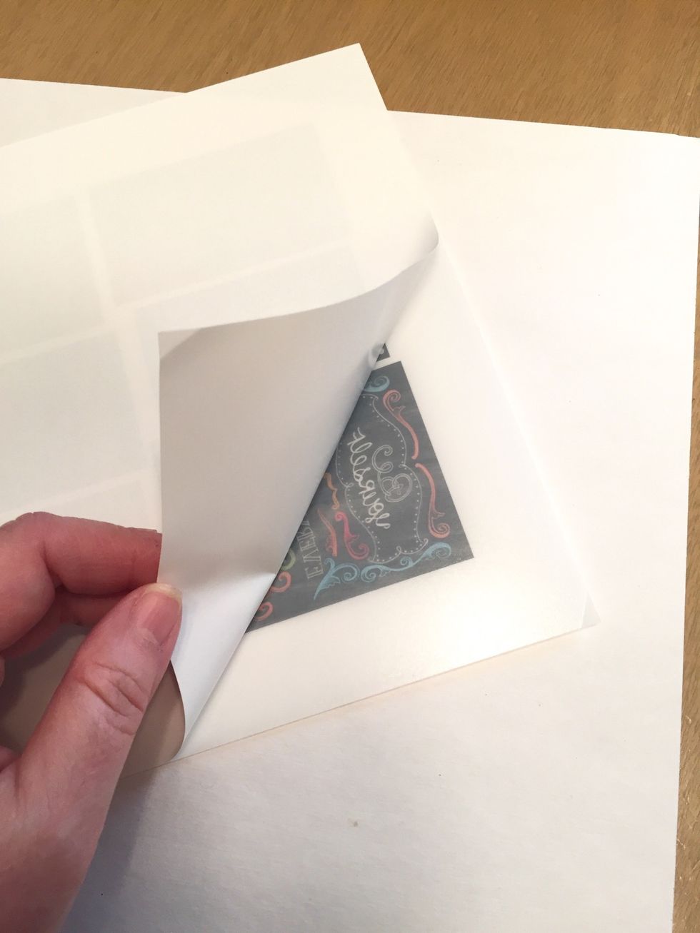starting with a corner, remove a portion of the backing from the sheet to expose the adhesive.
