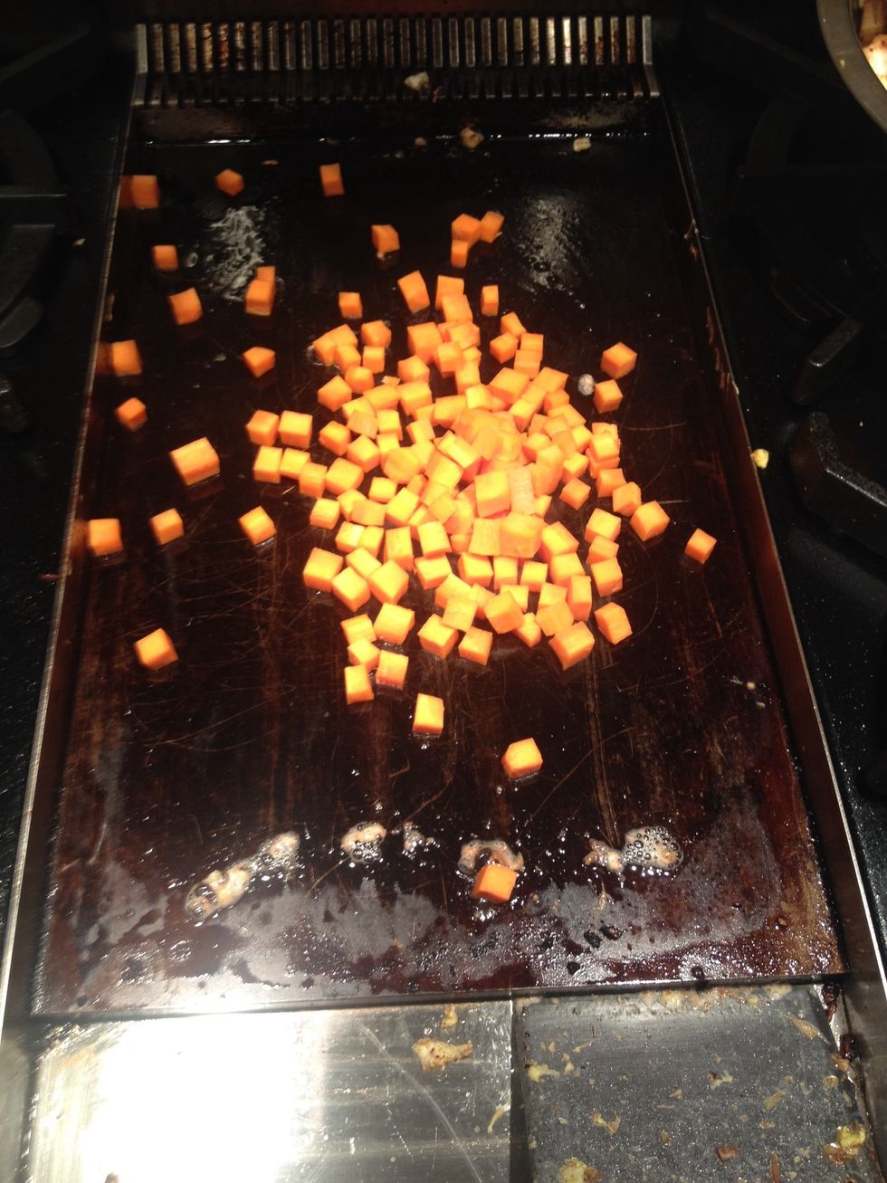 Starting with carrots. Add a touch of salt. With oil of course. Cook a for maybe 2 or 3 minutes