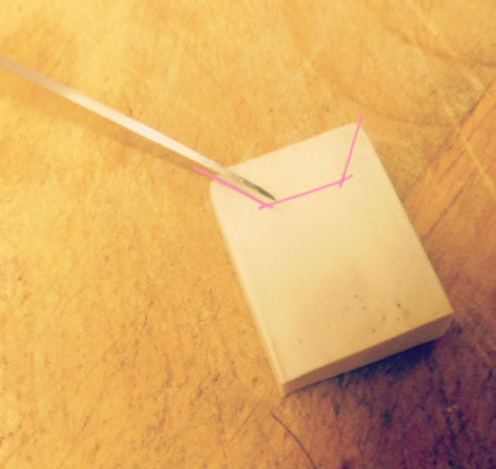 Starting with one of your eraser you want to cut a diagonal line from both corners (the pink lines above are guides to show you what cuts will be necessary)