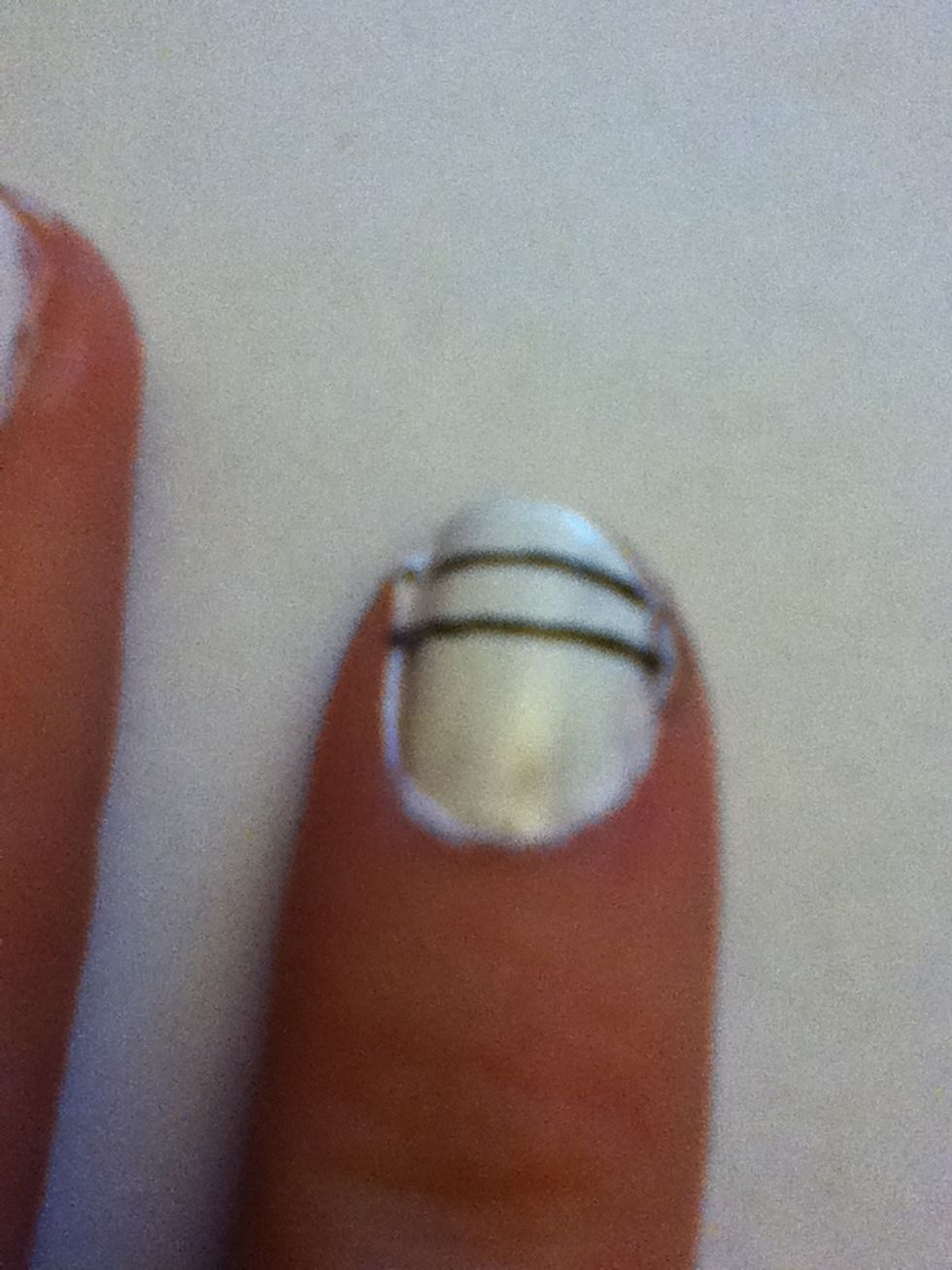 Starting with the index finger, draw two lines with the black nail art pen (like shown above)