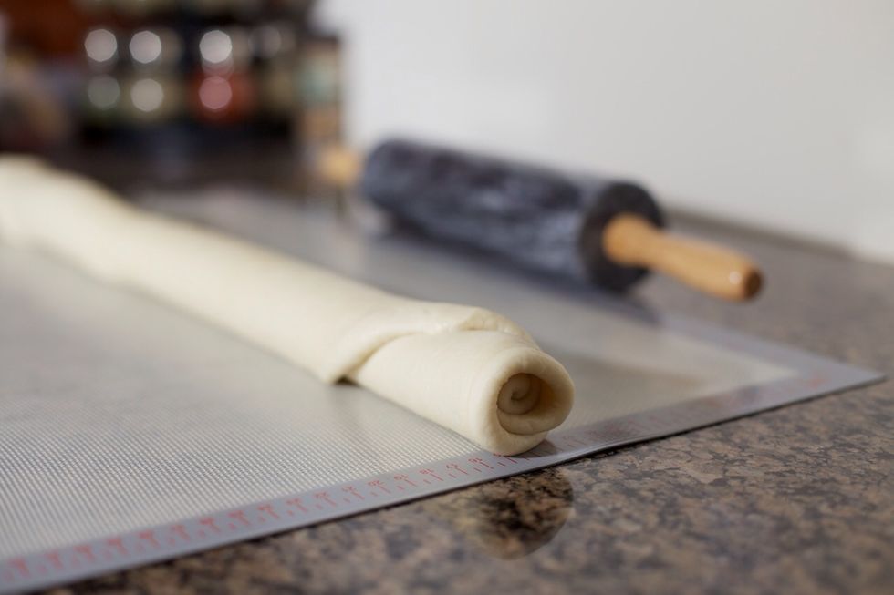 Starting with the long end, roll it into a tight log.  Squish the seams together, then form it back into a log.  Cut the log in half, then each piece in half again until you have 16 pieces.