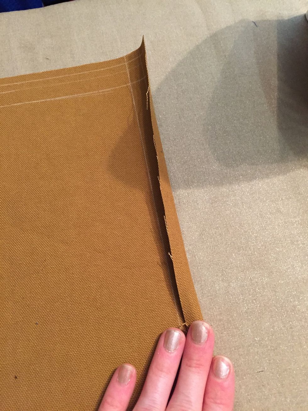 Starting with the short sides, fold and press 1/2", then fold and press 1/2" again to hide raw edges. Repeat with long edges and pin.