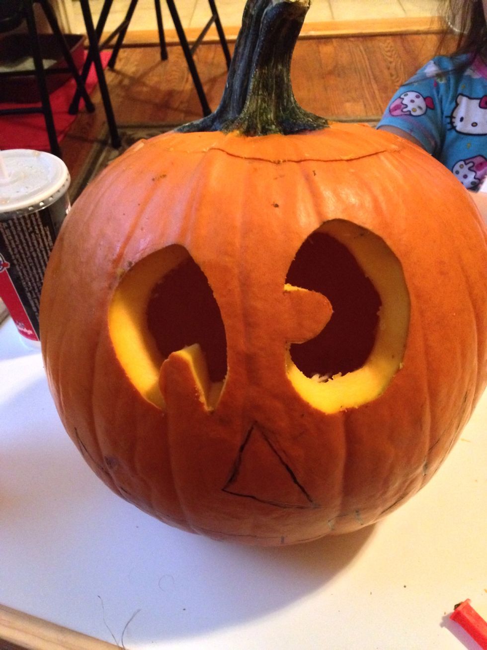 Starting with the smallest carving knife in your kit, cut slowly along the lines that you've drawn on your pumpkin.After all the lines have been cut, put your hand inside and push the pieces out.