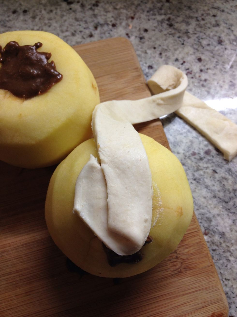 Starting with the top opening of your apple, make a 'v' shape to cover the centre opening like so...