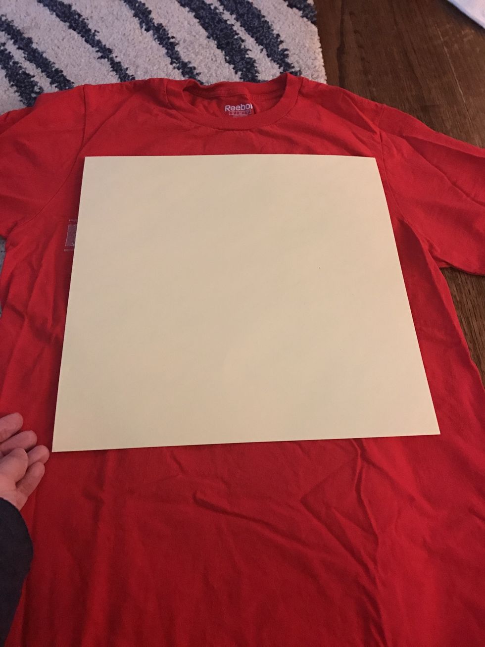 Starting with your first shirt, line up the paper template so that the design is centered.