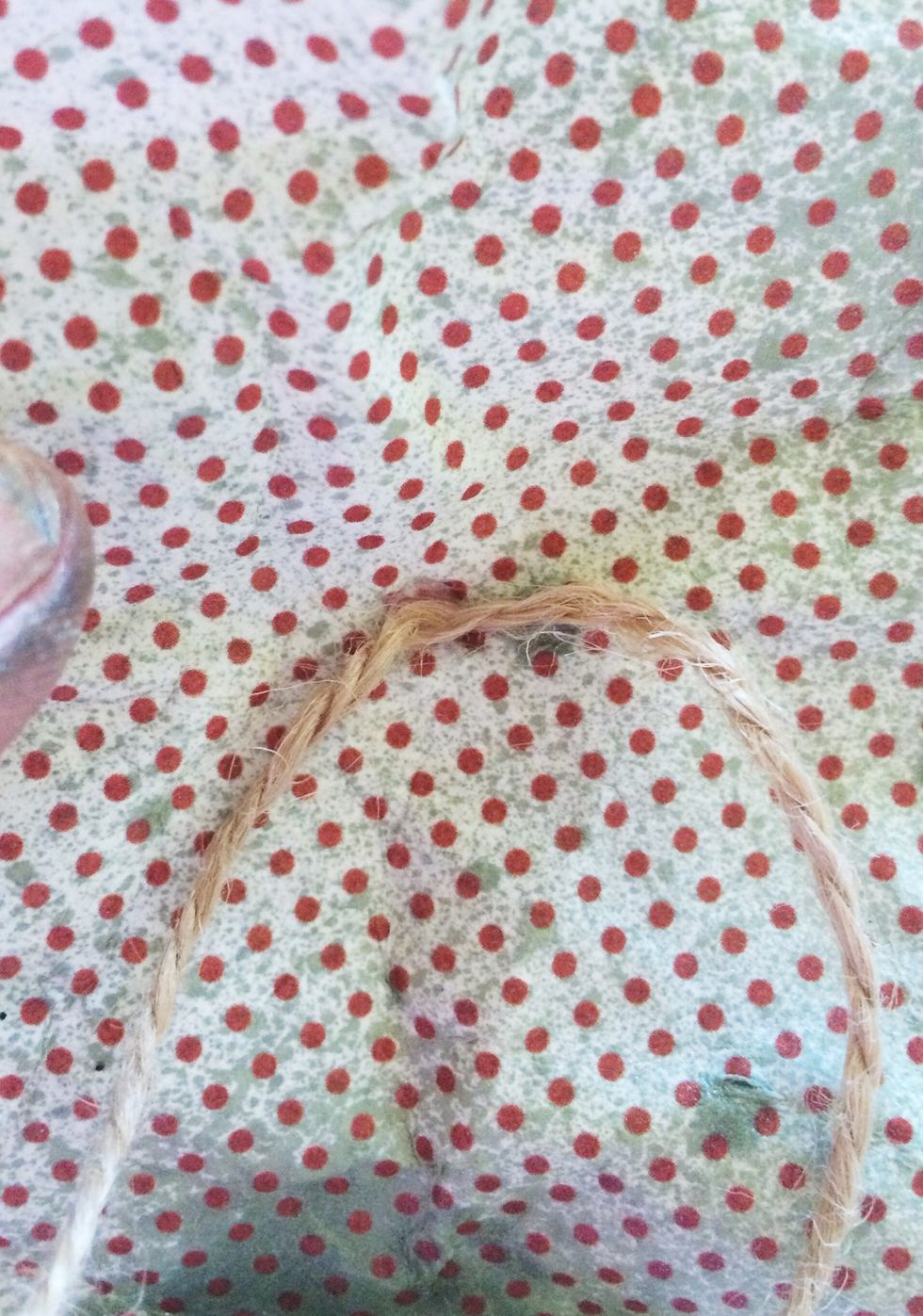 Starting with your largest circle and using the looped end of your rope, poke your rope through the hole you made.