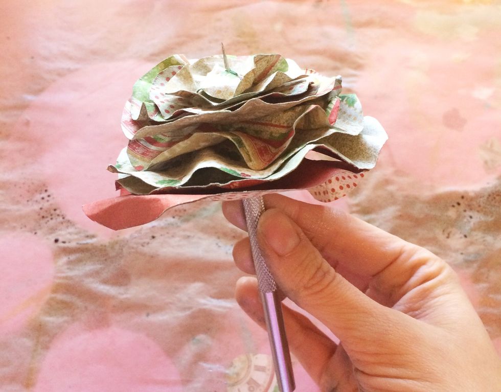 Starting with your largest circle, stack your layers onto a paper piercer. This will allow you to line up your string down the center of your circles. Don't worry it's not perfect!