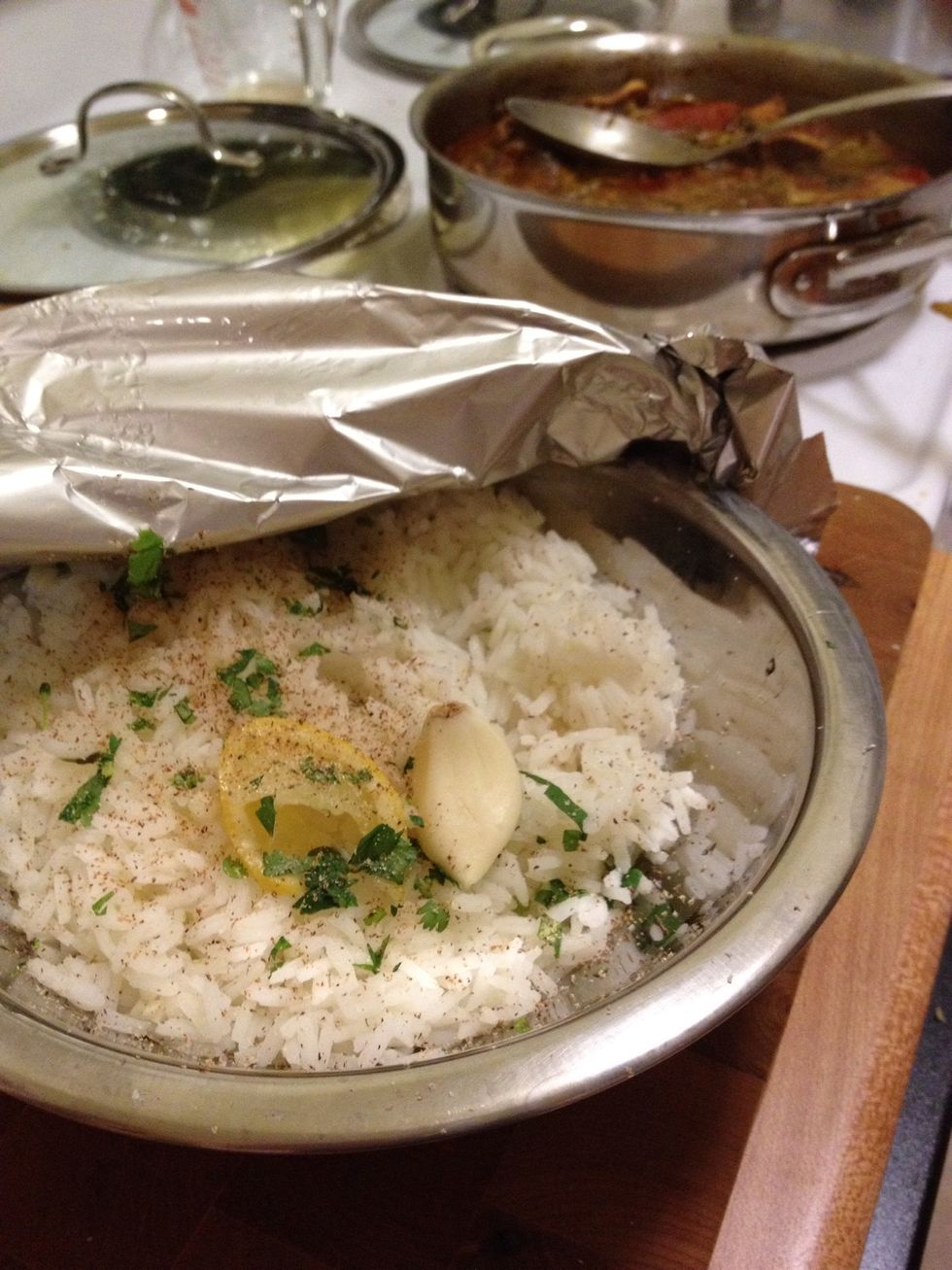 Steam rice until tender(~15m). My rice was done before the curry so I did this. Pinch of cilantro, an squished garlic clove, lemon wedge, grated nutmeg and a pinch of salt. It scented the rice nicely.