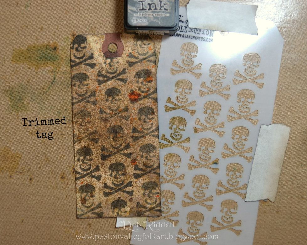 Stencil the second trimmed tag front and back with the crossbones mini stencil and Hickory Smoke DI