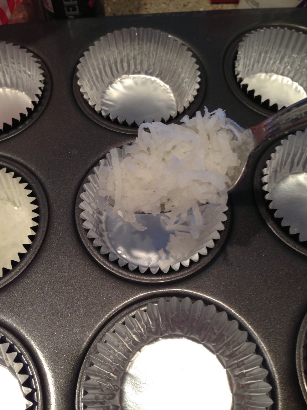 Step 1: add a teaspoon of coconut to the bottom of each cupcake wrapper.