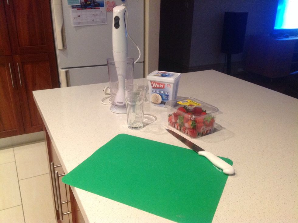 Step 1: collect equipment : Food processor, knife, vanilla yoghurt, glass, chopping board, milk and strawberries. ps. I forgot to put milk in the picture.