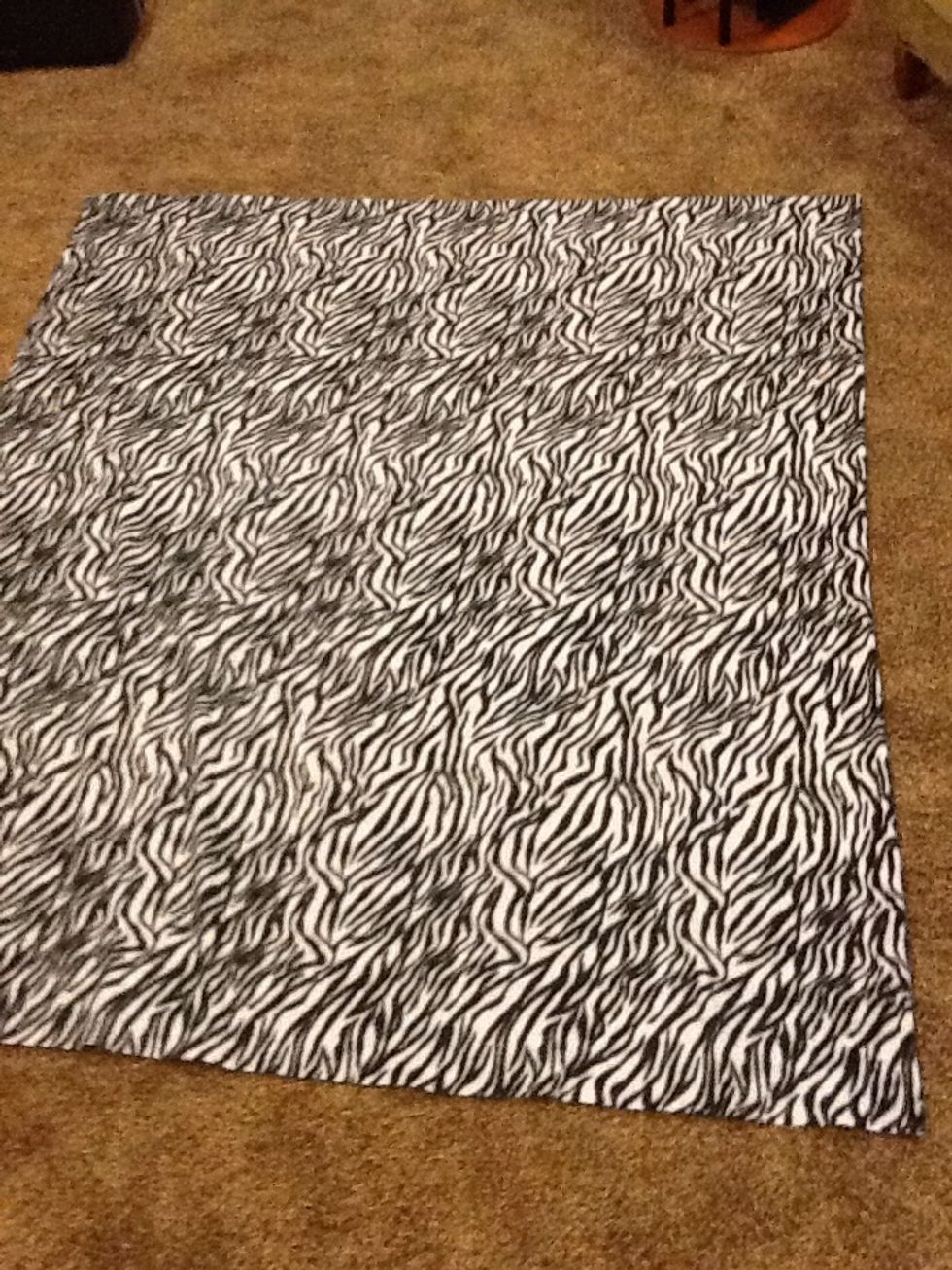 Step 1. First lay down one of your blankets. Make sure there are no wrinkles .