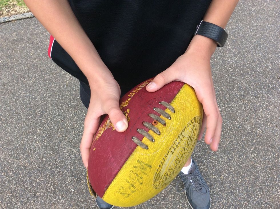 Step 1 pick up the ball with your hands and hold it like this it\u2019s similar to the torpedo just different side.