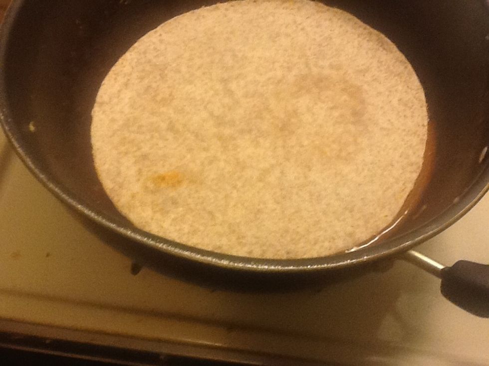 Step 1: Put the tortilla inside the enchilada sauce vessel or you can spread the sauce on top of tortillas