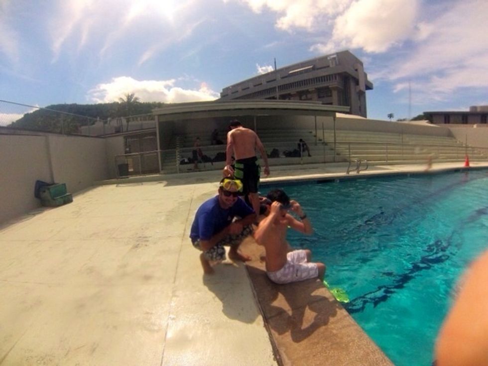 Step 1: Put your gear on before entering the pool and make sure your goggles are tight enough, so water doesn't fill in them. Make sure your fins fit your feet because you don't want them to fall off.