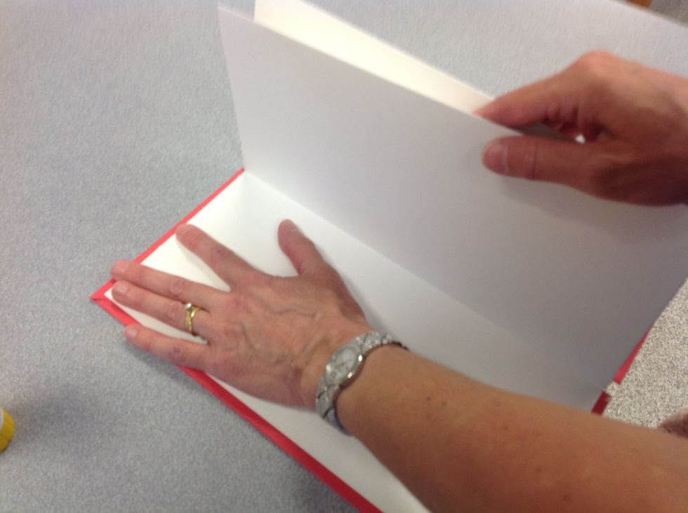 Step 10: Glue the first accordion fold to the inside cover of your book, flush with the outside of the book. This is best done with a glue stick.