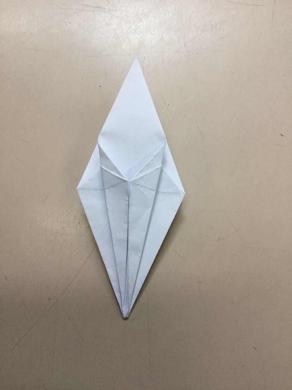 Step 10: Use your hands and at the bottom fold one edge to the centre crease, line it up, crease and continue on the rest of the edges.