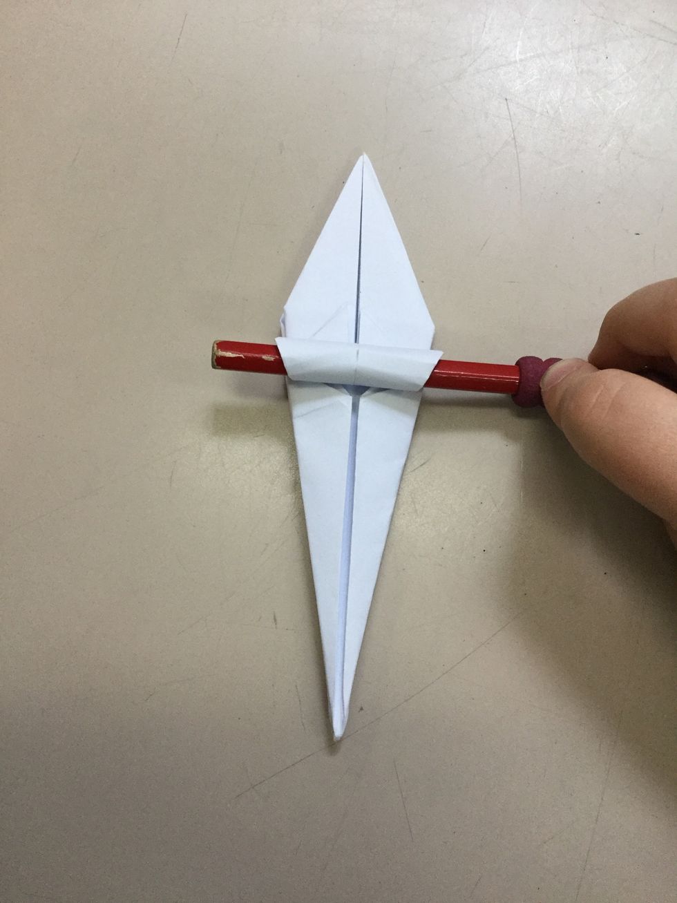 Step 11: Use your hands and pick up a pencil/ pen and use it to curl the flaps on the top of the paper and hold for 10 seconds and remove. Repeat on all sides.