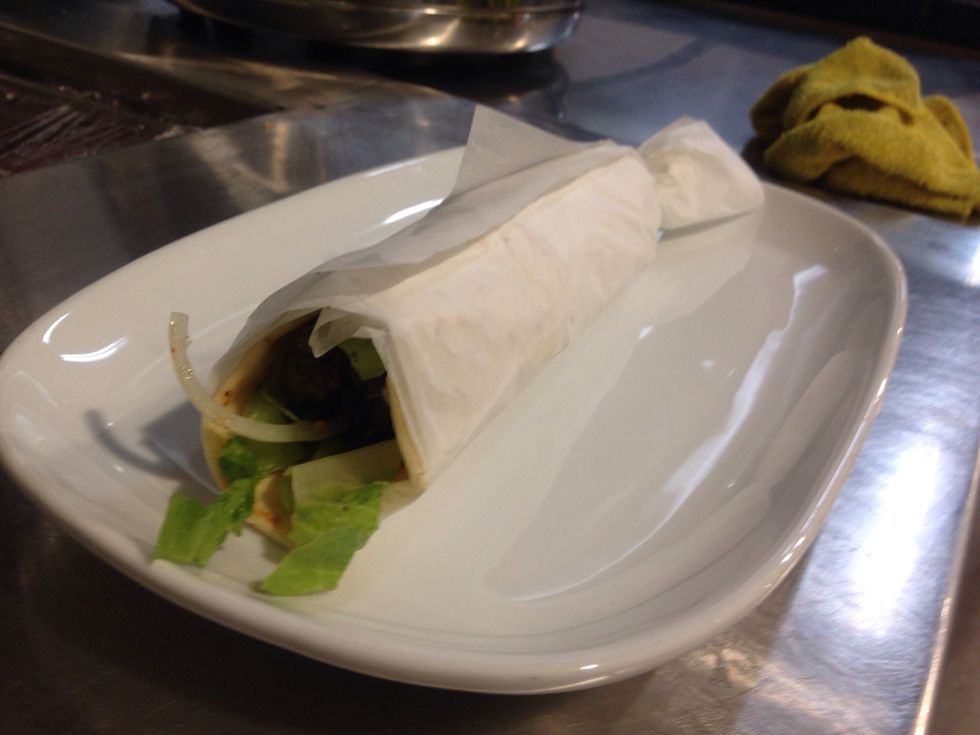 Step 11: Wrap up souvlaki. Hold tightly and remove skewer from lamb.