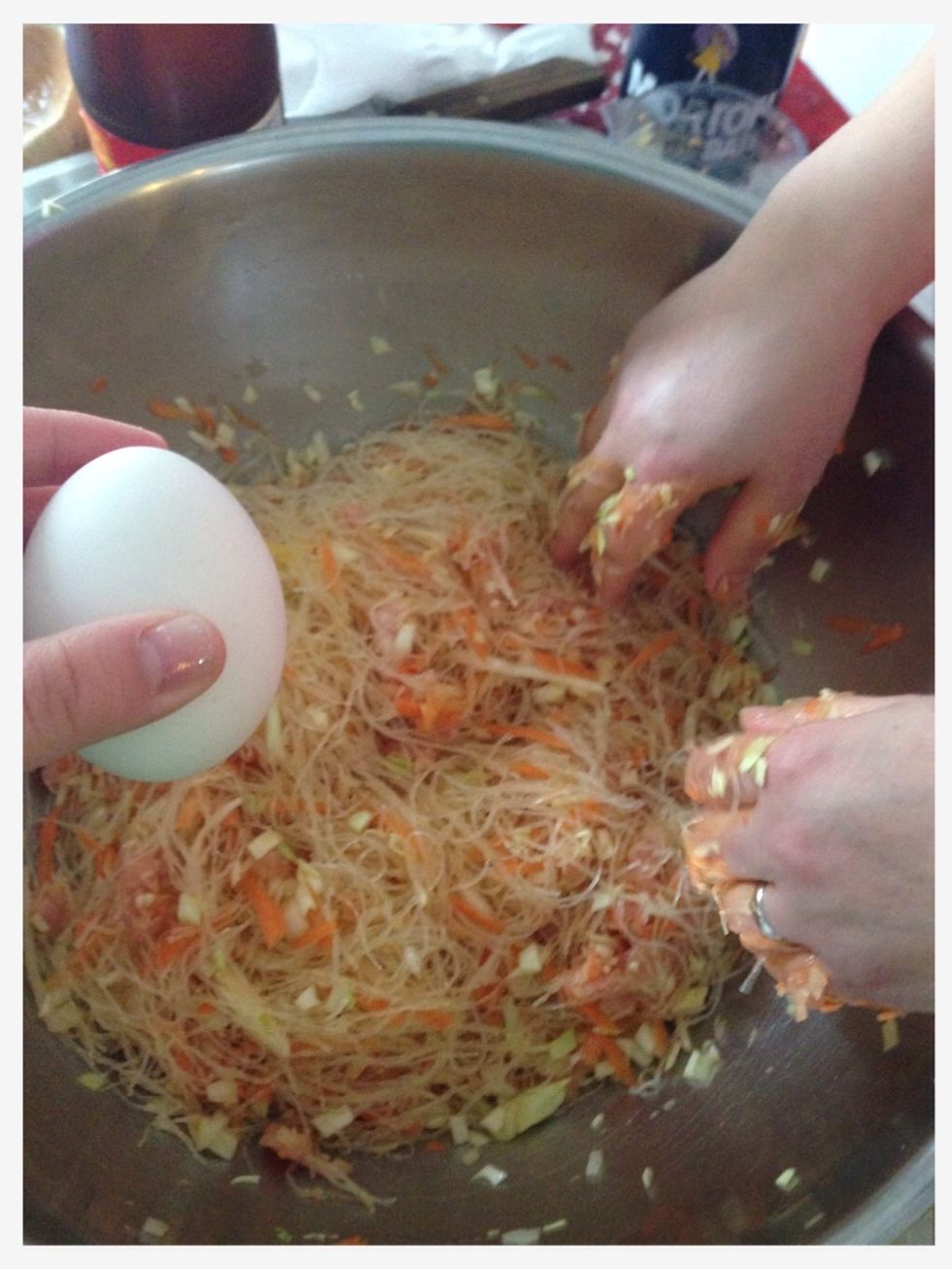 Step 12: Crack 2 eggs and mix them into the mixture.