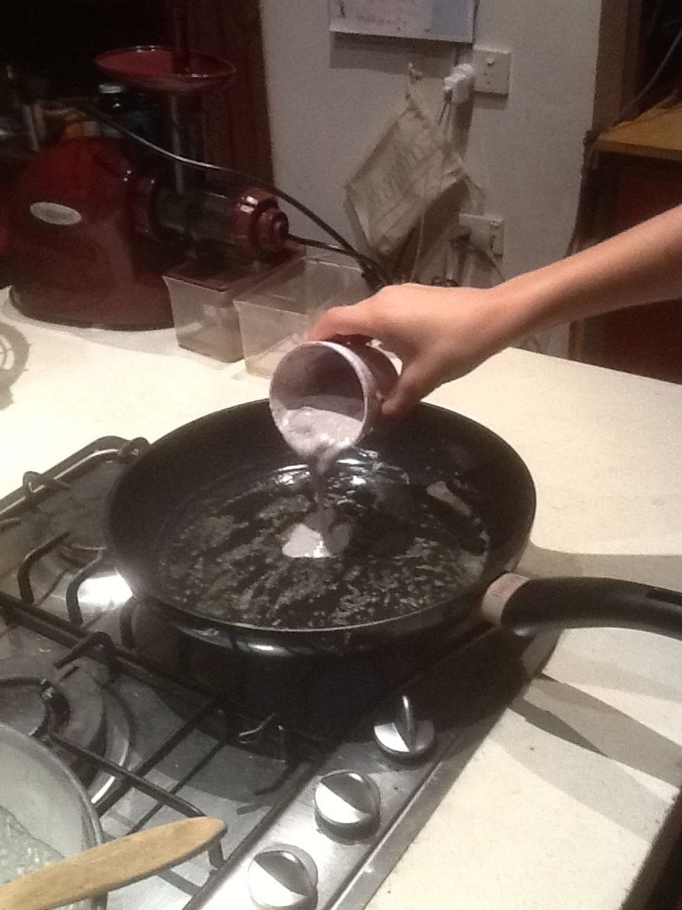Step 12: Pour a quarter of a cup of mixture into hot pan.