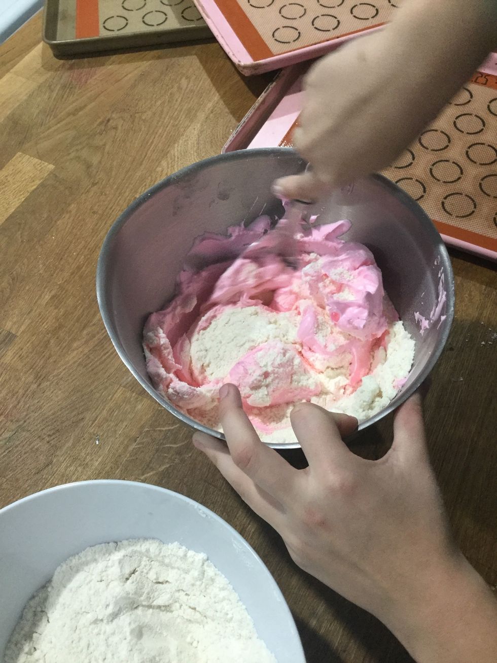 Step 14: Add another third of the meringue and fold it into the mixture.