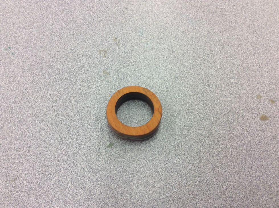 Step 18: after your done that then grab a drill bit and put the ring in it, then grab a drill and sand paper and tape, and then tape down the sandpaper and then sand away! After it will look like this