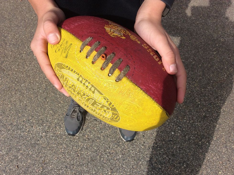 Step 1Pick up the football with your hands and put it around your hips and hold it like the picture shown. When kicking a torpedo it needs to be on a slight angle if it\u2019s not it won\u2019t work.