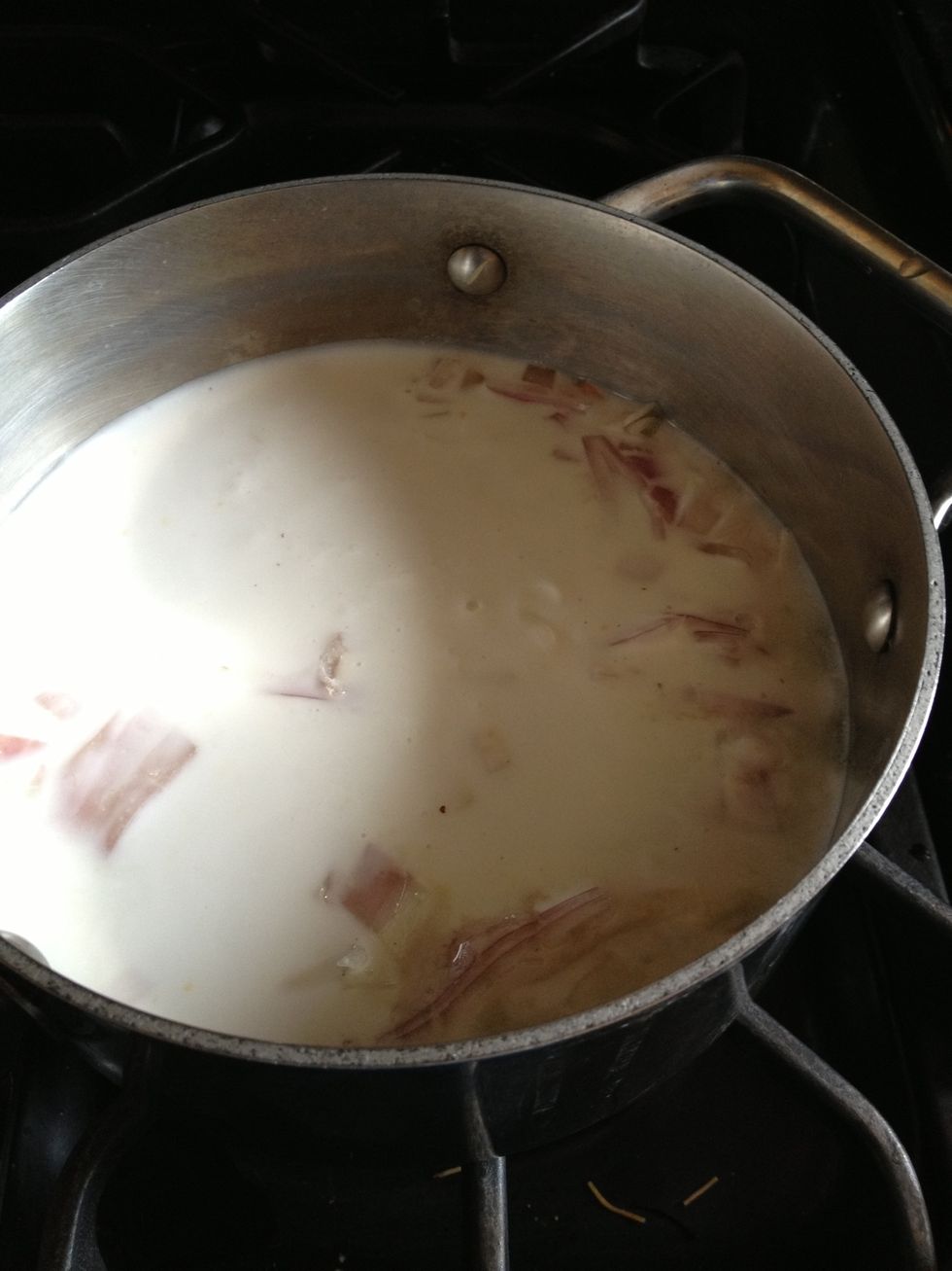 Step 2: Combine ginger, shallots, salt, coconut milk and half the amount of water (use can to measure out half can) and bring to gentle boil on medium heat.