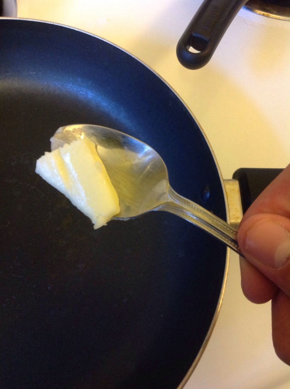 Step 2: once the stove is heated up, get a spoon full of butter and let it melt on the pan/skillet (this is for that savory butter flavor) (more or less butter depending on your preferences)