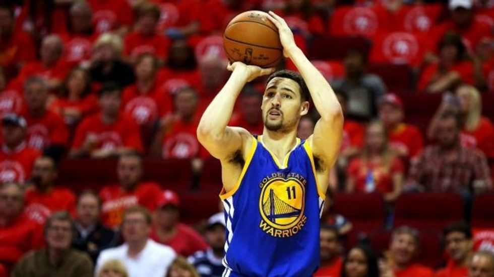 Step:2 Once you are balanced make your elbow an L shape make sure your elbow isn't sticking out. Balance the ball on your finger tips, place your non-shooting hand on the other side of the ball.