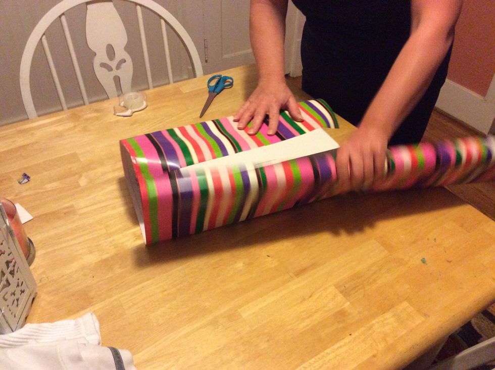 Step 2: Open the wrapping paper and wrap it around your present.