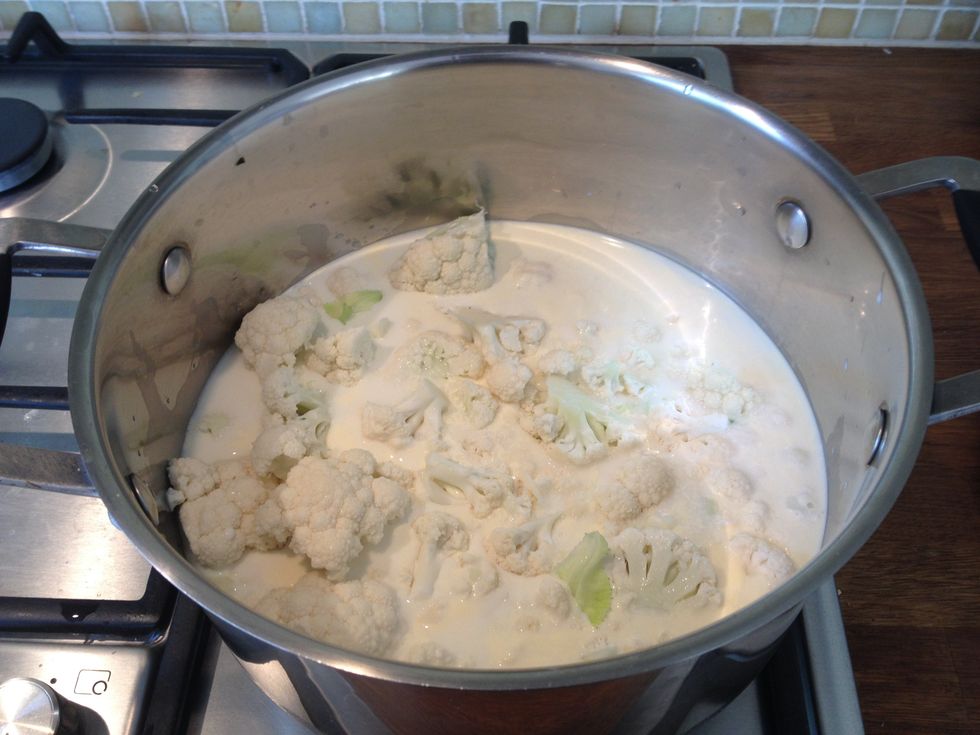 Step 2. Place the cauliflower florets in a pan with the milk, cream and the bay leaf. Simmer over a low heat until the cauliflower is tender and soft.