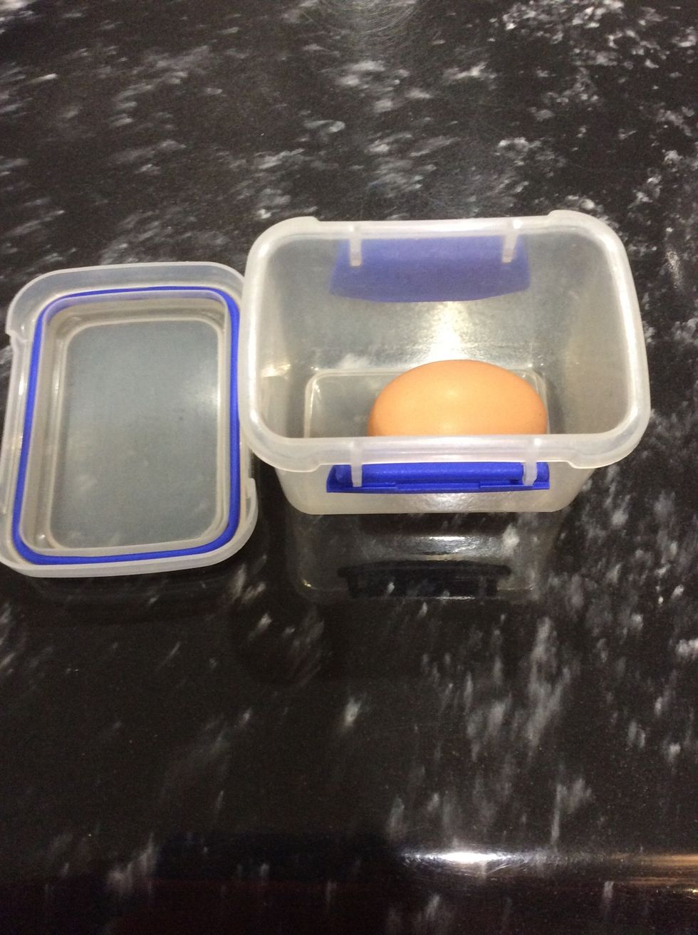 Step 2:Put your egg in side the medium size container carefully.