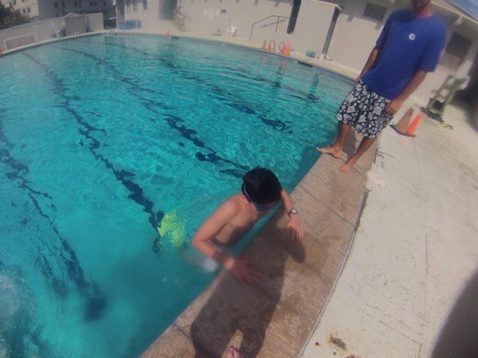 Step 2: Slowly enter the water in the shallow end of the pool, where your can comfortably stand or hold onto the wall of the pool.