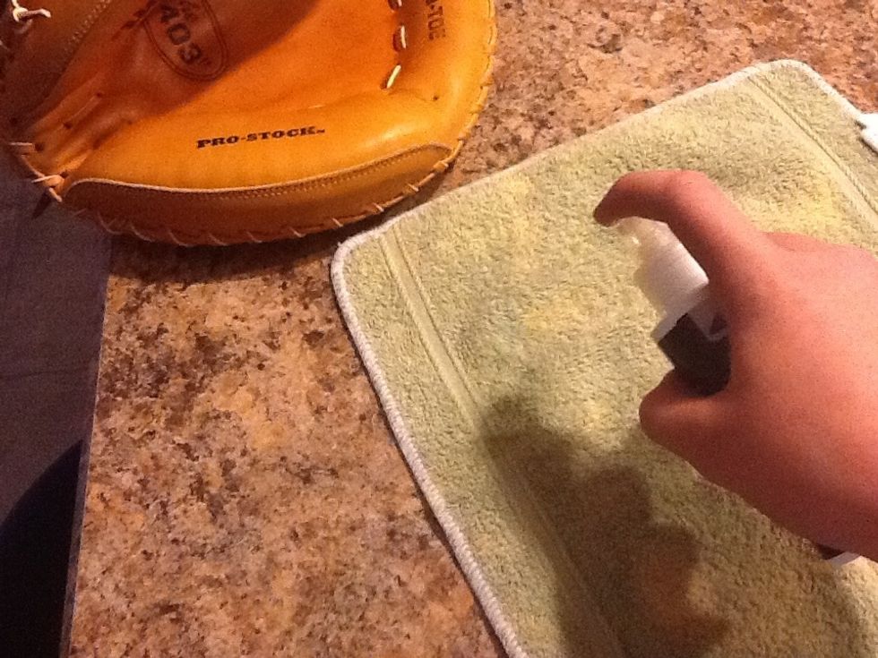 Step 2.) Spray oil/conditioner onto the rag and wipe on glove within the pocket and do so until inside is darker and somewhat moist